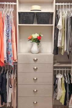 an organized closet with drawers and clothes