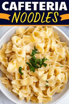 a white bowl filled with pasta and parsley