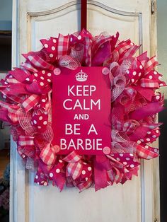 a pink and red wreath with polka dots on it that says keep calm and be a barbie