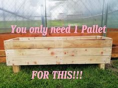 a wooden planter sitting in the grass next to a fence with words you only need 1 pallet for this