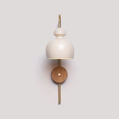 a white wall light with a wooden base