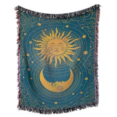 a tapestry with the sun and moon on it's side, hanging in front of a white wall