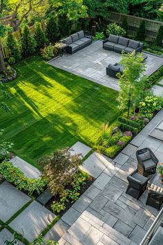 an aerial view of a backyard with lawn and seating