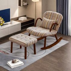 a living room with a rocking chair and footstool in front of a flat screen tv