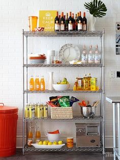 a metal shelving unit with lots of bottles and drinks on it's shelves