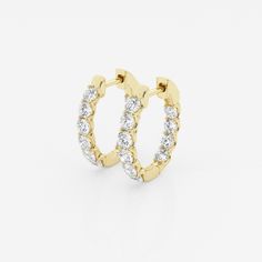 two gold hoop earrings with small diamonds on the inside and outside, set against a white background