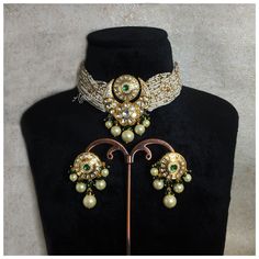 Sabyasachi Inspired Green Kundan Choker features a blend of emeralds, pearls, and Polki stones set in antique gold. The Jadau craftsmanship adds a regal touch, making it a stunning statement piece. Perfect for enhancing traditional and modern ensembles with its exquisite design and elegance..  *𝐏𝐑𝐎𝐃𝐔𝐂𝐓 𝐃𝐄𝐓𝐀𝐈𝐋* * Material: Brass * Plating: Gold Plated * Stone:  Semi Precious CZ Diamond, Kundan, Polki & Green Beads *𝐃𝐈𝐌𝐄𝐍𝐒𝐈𝐎𝐍𝐒* *Necklace* * Weight:  37 gm Each * Length:-8.2 Traditional Jeweled Kundan Necklace For Formal Occasions, Traditional Green Pearl Necklace For Formal Occasions, Traditional Gold Jeweled Pearl Necklace, Traditional Chandbali Pearl Necklace For Formal Occasions, Traditional Meenakari Choker For Formal Occasions, Traditional Festive Choker For Formal Occasions, Traditional Festive Formal Choker, Formal Traditional Choker, Formal Festive Traditional Choker