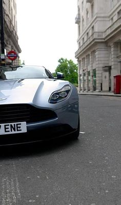 a silver sports car is parked on the street