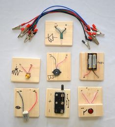 several pieces of wood with various electrical components attached to them, including wires and magnets