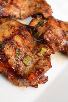 three pieces of chicken sitting on top of a white plate