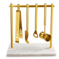 gold kitchen utensils hanging on a rack