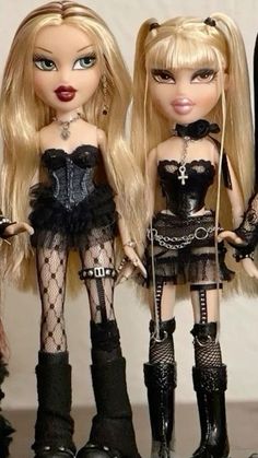 three dolls are standing next to each other