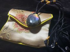 a small bag with a glass ball on it