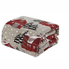 the blanket is covered in red and white christmas fabric, which has a farm scene on it