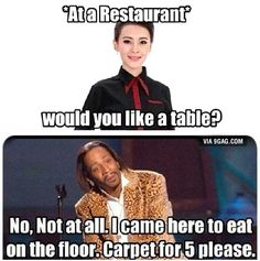 a woman in a suit and tie standing next to a microphone with the caption at a restaurant would you like a table? no, not at all i came here to eat on the floor carpet for 5 please