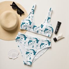 Introducing our Whale Shark blue and white polyester bikini! This eco-friendly, high-waisted, and modest swimsuit is perfect for a day at the beach or by the pool. Our cute whale shark and sting ray print are sure to turn heads, while the recycled material is both environmentally friendly and comfortable. The double-layered construction ensures that you'll stay modest, while the removable pads provide a customized fit. So what are you waiting for? Order yours today! * Fabric composition in the EU: 88% recycled polyester, 12% elastane * Double-layered and non-reversible * Removable padding * Tear-away care label * Zig-zag stitching Cute Whale Shark, Coconut Beach, Cute Whales, Modest Swimsuits, Coconut Girl