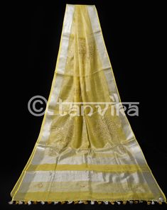 This elegant tissue linen drape in a beautiful gold tone features the beautiful and meticulously done floral cutwork design. This saree has pretty faux mirror (flattened sequin discs) work which adds a lovely vibe and bling to the whole outfit. The saree might have slight irregularities in the pattern & colors, which results from the human involvement in the process & is a hallmark of handcrafted products. Minor thread pulls are not considered damage. We recommend professional dry cleani Gold Dupatta With Resham Embroidery In Cotton Silk, Gold Cotton Silk Dupatta With Gota Work, Gold Cotton Silk Saree With Gota Work, Gold Slub Silk Traditional Wear With Chikankari Embroidery, Gold Chikankari Embroidery Slub Silk Traditional Wear, Celebration Tussar Silk Dupatta With Gota Work, Elegant Tussar Silk Saree With Gota Work, Gold Traditional Wear With Chikankari Embroidery In Raw Silk, Celebration Tussar Silk Saree With Gota Work