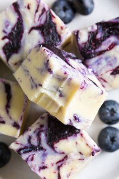 blueberry cheesecake fudges on a plate with fresh berries