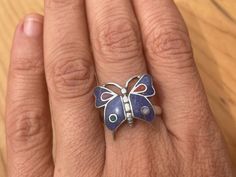 This beautiful blue butterfly is made by hand by the beautiful Quechua people of the Peruvian Andes. It is made by 950 silver, Lapiz Lazuli and Spondyllus Weight : 4.9 gr width: 1.9 cm height: 1.9 cm It is handmade in 950 silver with inlaid stone and shell by a local family of jewelry artisans. Bohemian Butterfly Ring As Gift, Bohemian Butterfly Ring As A Gift, Unique Handmade Butterfly Ring, Bohemian Butterfly Ring For Gift, Handmade Sterling Silver Butterfly Ring, Blue Butterfly Sterling Silver Jewelry, Handmade Bohemian Sterling Silver Butterfly Ring, Silver Gemstone Butterfly Ring In Sterling Silver, Bohemian Handmade Sterling Silver Butterfly Ring