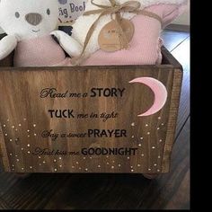 two teddy bears sitting in a wooden box with words on the front and back side