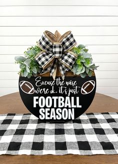 a football themed centerpiece on top of a table with a checkered table cloth