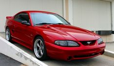 a red sports car parked in front of a building