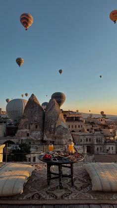 hot air balloons are flying over the city in cappads at sunset or dawn