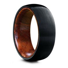 the black ceramic ring with wood inlays is shown on a white background,