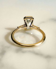 a close up of a diamond ring on a table