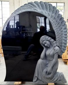 a statue sitting in front of a large mirror