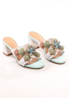 Step into seaside elegance with our Kailini Sandal from the Under the Sea collection. Made in Italy, these stunning sandals are adorned with rhinestone starfish and coral pendants, transforming them into wearable art. Perfect for adding a touch of oceanic charm to any outfit, the Kailini Sandal is a testament to exquisite craftsmanship and unique design. Make a splash in style and elevate your wardrobe with these captivating sandals. Luxury Embellished Summer Sandals, Luxury White Beach Heels, Luxury White Heels For Beach, Luxury Open Heel Sandals For The Beach, Elegant Embellished Beach Sandals, Glamorous Embellished Sandals For Vacation, Elegant Embellished Sandals For Vacation, Glamorous Open Heel Sandals For Beach, Elegant Crystal Embellished Sandals For Vacation