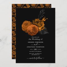 an orange and black wedding card with flowers