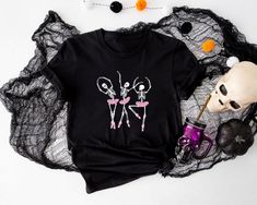 Ballerina Halloween Shirt, Dancing Skeleton, Ballet, Ballet Shirt, Halloween Gift, Ballet Gift, Dance Teacher, Halloween Party,Spooky Season How to Order T-shirt  1-        Please, check and review all photos 2-        Please choose your t-shirt style and size 3-        Please choose your t-shirt color 4-        Click add to cart. 5-        Please click the "Proceed to Check Out" button. Important Notice 1- We have multi brand shirts. Your order may contain different brand of t-shirts. If you want specific brand please let us know at the order stage. 2- Measurements shown on the chart may vary by +/- 10%. Product and Washing  We are doing DTF. Shirts Solid Colors are %100 cotton. Heathers are %52 cotton %48 polyester. Sweatshirts %50 cotton %50 polyester. Wash the  inside of the T-shirt in Halloween Punk Stretch Tops, Fitted Witchy Top For Halloween, Witchy Black Party Top, Black Tops For Halloween Costume Party, Fitted Black T-shirt For Halloween, Black Stretch T-shirt For Halloween, Spooky Fitted Tops For Halloween, Spooky Fitted Halloween Tops, Gothic Party Tops With Skull Print