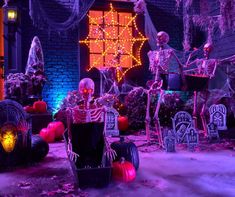 halloween decorations in front of a house decorated for the holiday season with pumpkins, jack - o - lanterns and skeletons