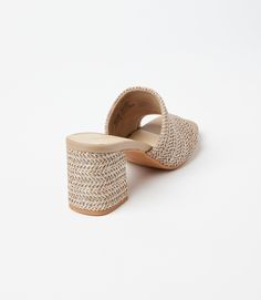 Conquer your day with ease with these raffia slides that strike the perfect balance between a walkable heel height and on-trend style. This design features padded OrthoLite Hybrid insoles and a patented down curve, ensuring a natural and comfortable stride with arch support. The raffia material adds a hint of texture and a bohemian charm, making these sandals a versatile addition to your wardrobe. Raffia upper Heel height: 2 3/4 inches Imported True to size Seychelles | Karen Kane Adapt Raffia H Chic Beige Woven Sandals, Chic Beige Woven Mules, Luxury Woven Beige Sandals, Raffia Sandals Heels, Beige Stitched Sole Slip-on Sandals, Karen Kane, High Heel Sandals, Sandals Heels, Heel Height