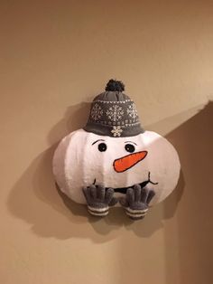 a stuffed snowman is hanging on the wall