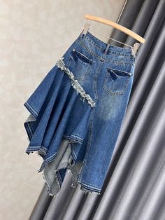 a denim skirt hanging on a clothes rack