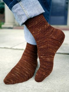 a person wearing brown socks and blue jeans