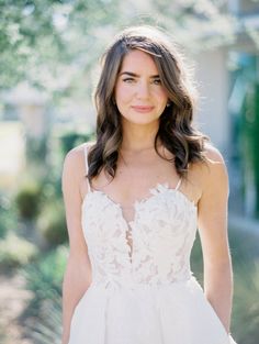 a woman in a wedding dress posing for the camera