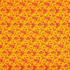 an abstract yellow background with small red and pink sprinkles on the surface