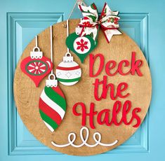 a wooden sign that says deck the halls with ornaments hanging from it's sides