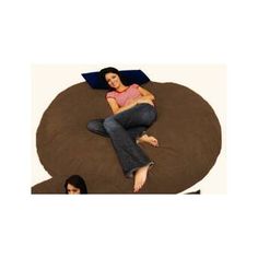 a woman laying on top of a bean bag chair