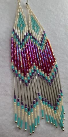 The multi colored bugle bead shines beautifully in the sun. These are approximately 5 3/4 inches in length, silver hooks. Beaded Earrings Diy, Seed Bead Patterns, Bugle Beads, Fringe Earrings, Jewelry Inspo, Diy Earrings, Aurora, Beading Patterns, Beaded Earrings