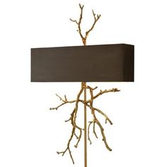 a table lamp with branches on it and a black shade over the light that is turned on