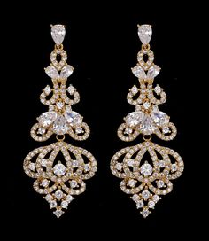 Gold Chandelier CZ Bridal Earrings This glamorous wedding and formal earring features dazzling AAA quality cubic zirconium (CZ) teardrop and round crystals in a unique gold plated chandelier design. These earrings will provide both sparkle and style to your wedding day, quinceanera or any special occasion. For pierced ears. Size: Earrings Measure 2 1/4" Long and 7/8" wide. Color: Light Gold/Clear. Style: e1002. Also a beautiful earring choice for your bridesmaids! Please allow 1 week for deliver Quinceanera Earrings, Cubic Zirconia Bridal Earrings, Prom Fashion, Formal Earrings, Gold Chandelier Earrings, Dazzling Earrings, Platinum Rose Gold, Zircon Earrings, Bride Earrings