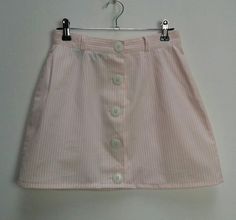 "a vintage pink and white stripe button-through high-waisted mini-skirt ✿ IMPORTANT INFORMATION: * excellent vintage condition * size: extra-small - please check exact measurements below (they're there for your benefit!) ✿ MEASUREMENTS (taken while item is lying flat, some measurements will need to be doubled): * length: 15\" (38cm) * waist: 12\" (30cm) * hips: 19\" (48cm) ✿ free UK shipping on orders over £100 with code STRAWBERRY free international shipping on orders over £250 with code LEMON Striped Summer Bottoms With Buttons, Striped Bottoms With Buttons For Summer, Pink Mini Skirt With Button Closure, Spring Mini Skirt With Vertical Stripes, Summer Mini Skirt With Vertical Stripes, Pink Pinstripe, Button Down Mini Skirt, Pinstripe Skirt, Mini Skirt Pink