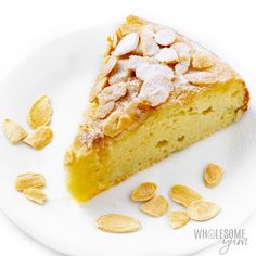 a piece of cake on a plate with almonds