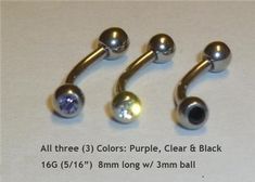 three different colored balls are attached to the back of a pair of fake piercings