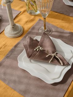 a place setting with napkins and wine glasses