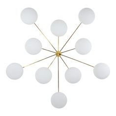 a chandelier with eight white glass balls hanging from it's brass frame